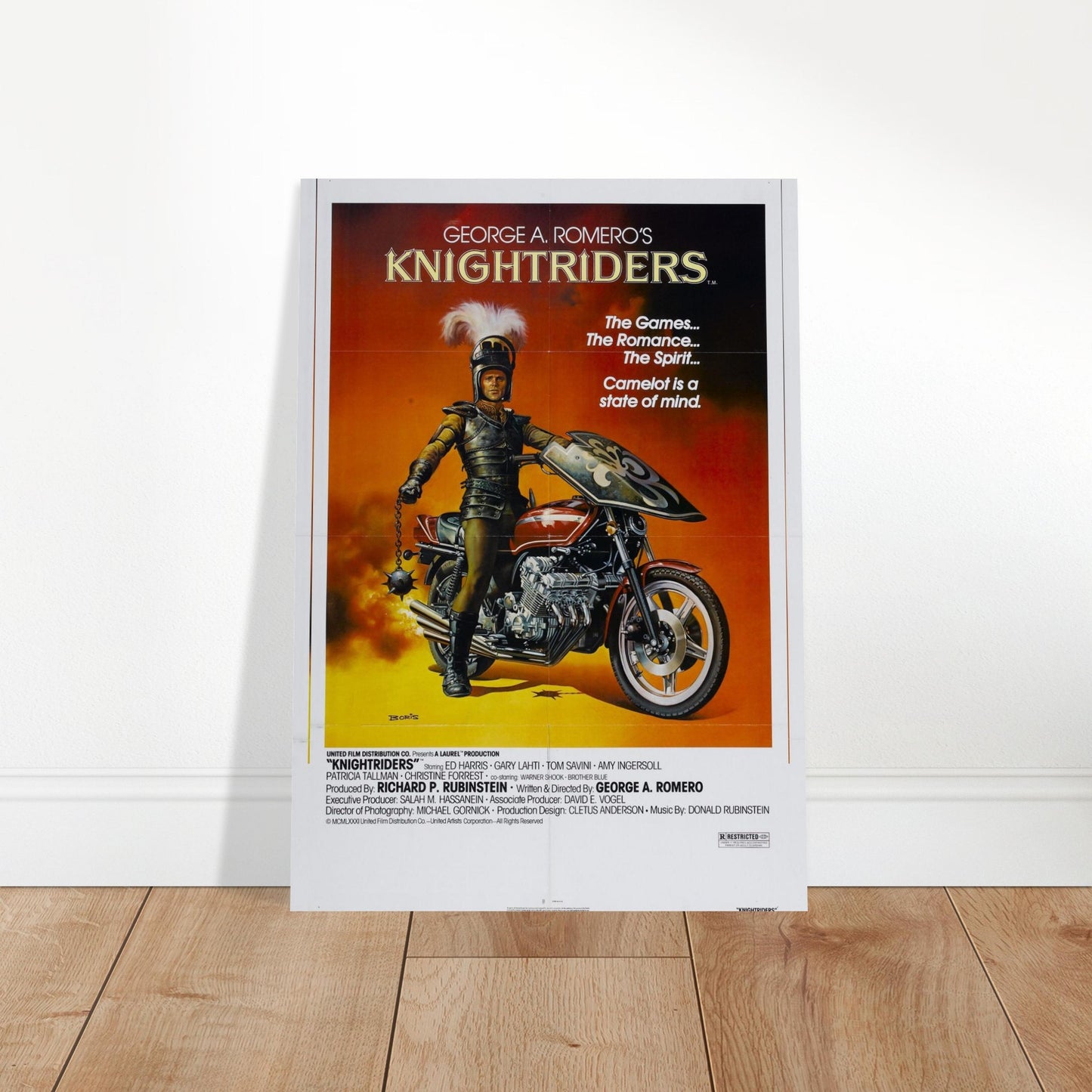 Knightriders vintage movie poster featuring a knight on a motorcycle against a fiery sunset backdrop. Perfect for collectors!
