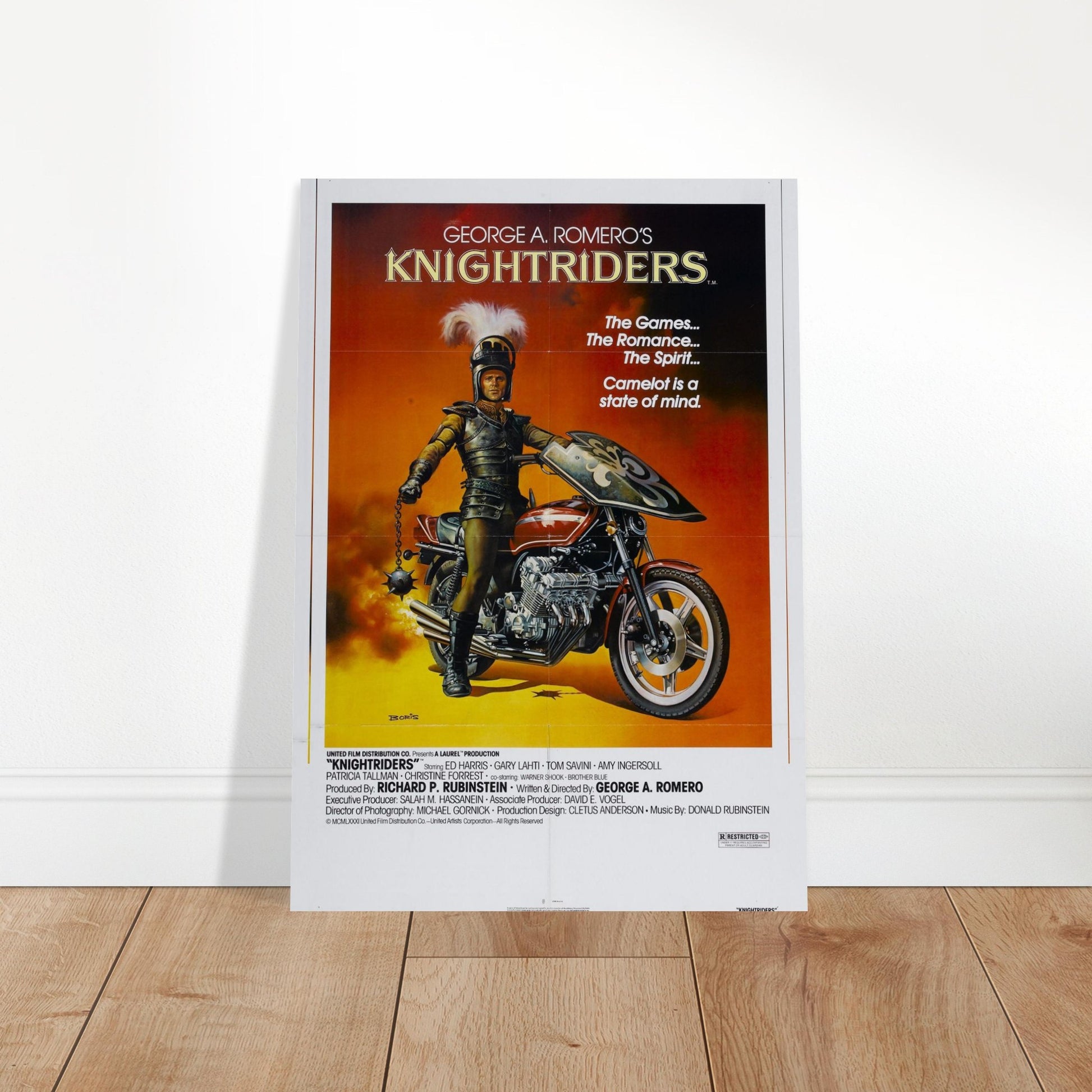 Knightriders vintage movie poster featuring a knight on a motorcycle against a fiery sunset backdrop. Perfect for collectors!